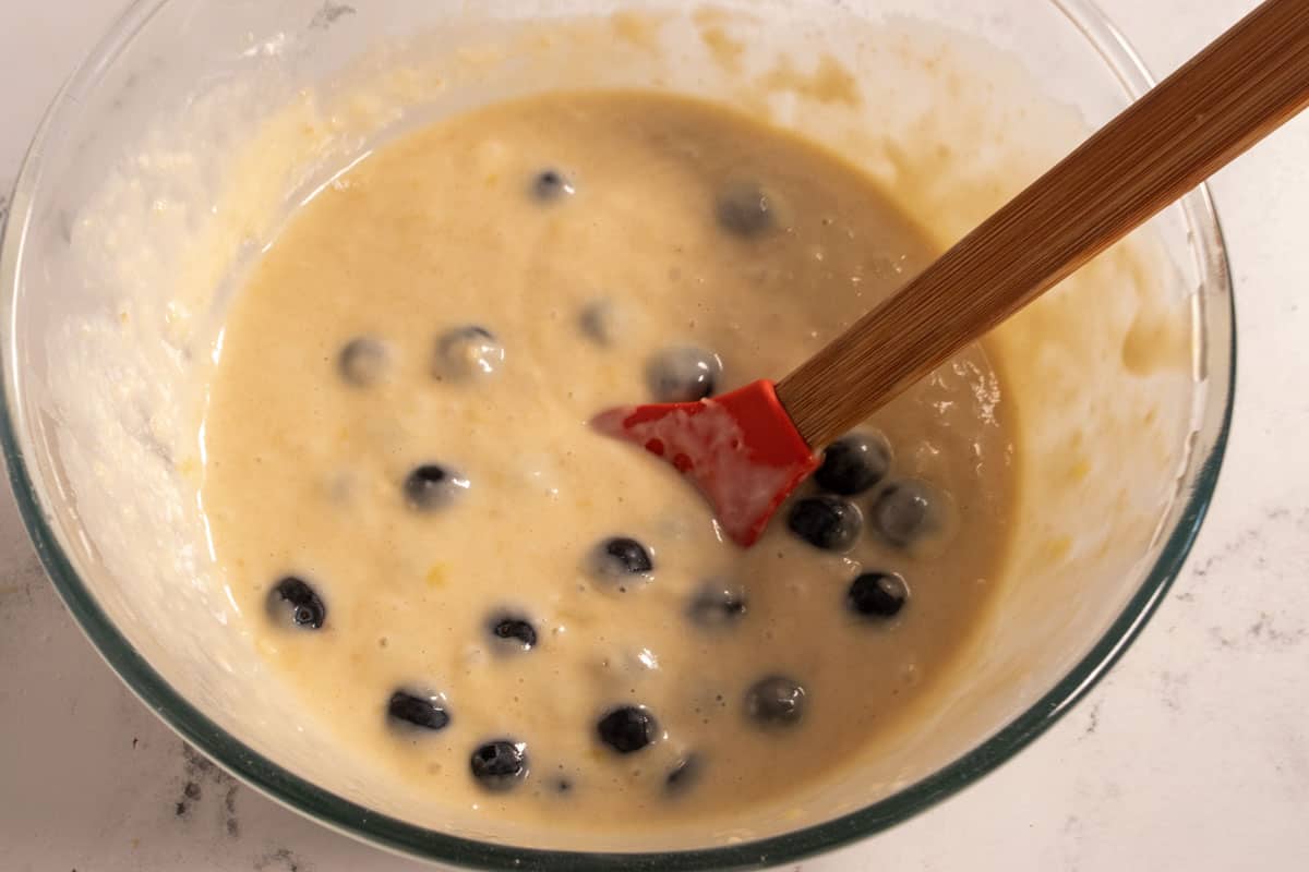 The dry ingredients and blueberries have been folded in, forming a batter. 