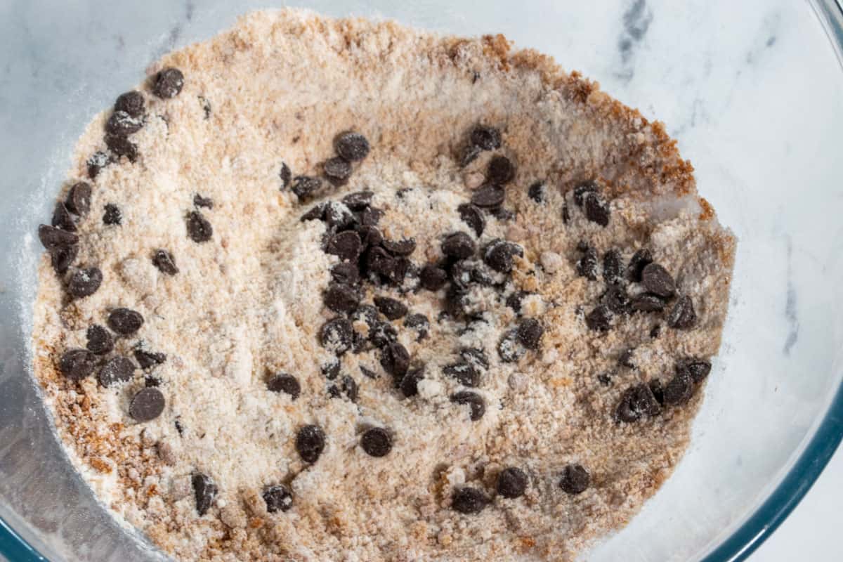 The dry cookie dough ingredients, mixed together inside a large pyrex bowl. 