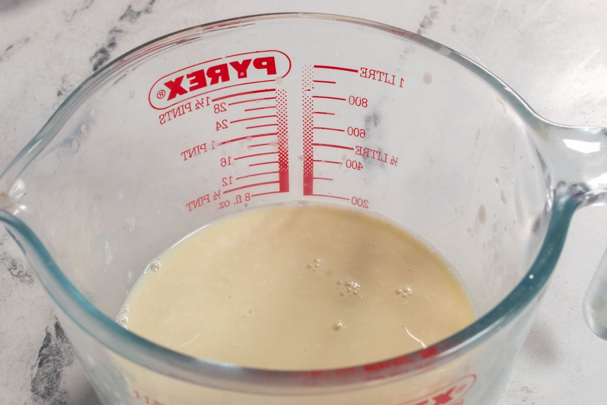 A pyrex jug containing vegan buttermilk. It is curdling. 