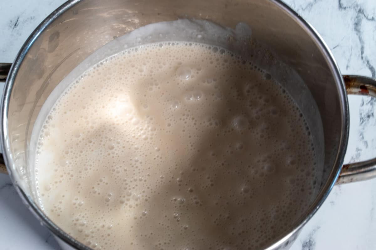 The coconut milk, coconut cream, sugar and salt, combined in a large pan. 