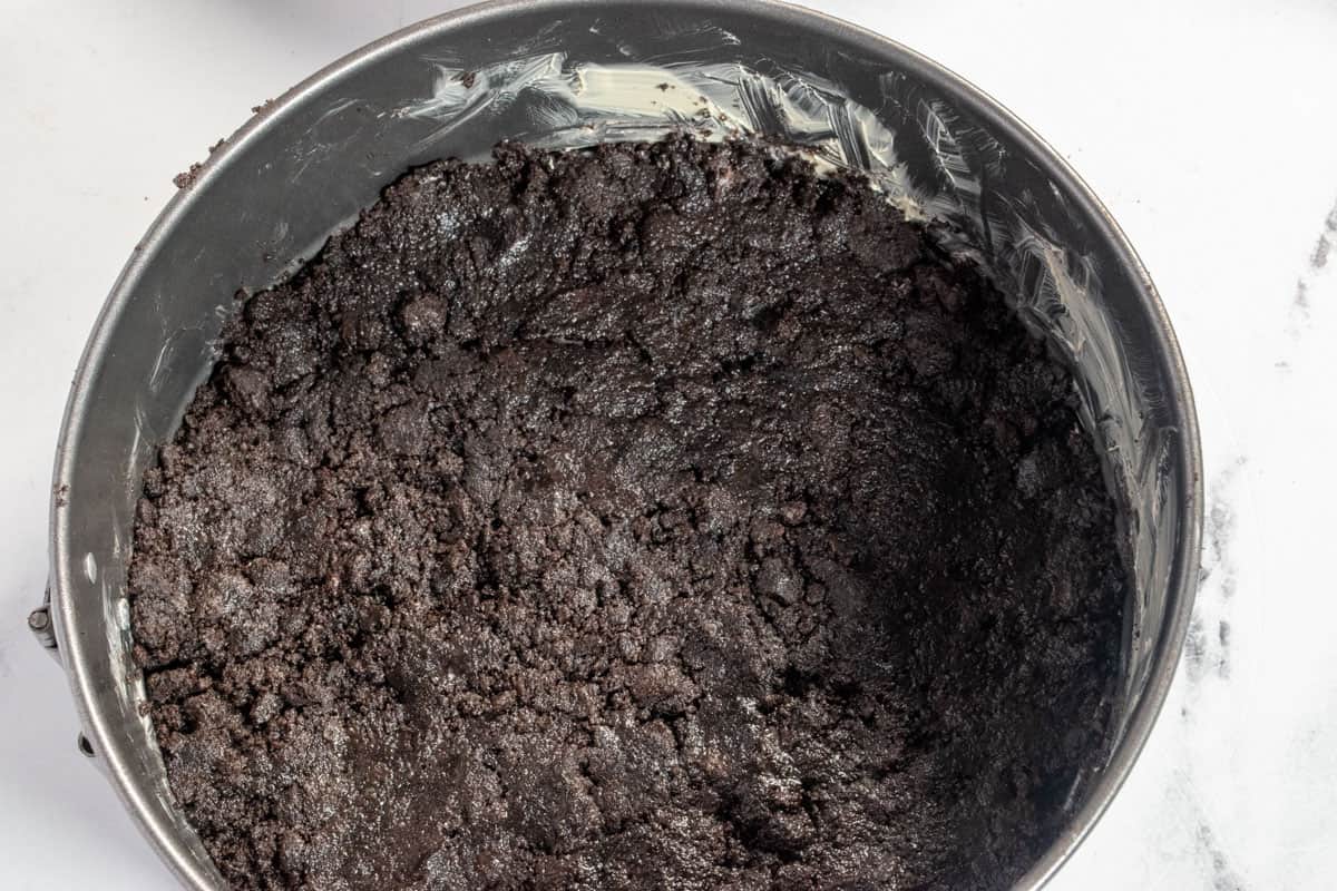 The crust ingredients have been pressed into the bottom of the tin. 