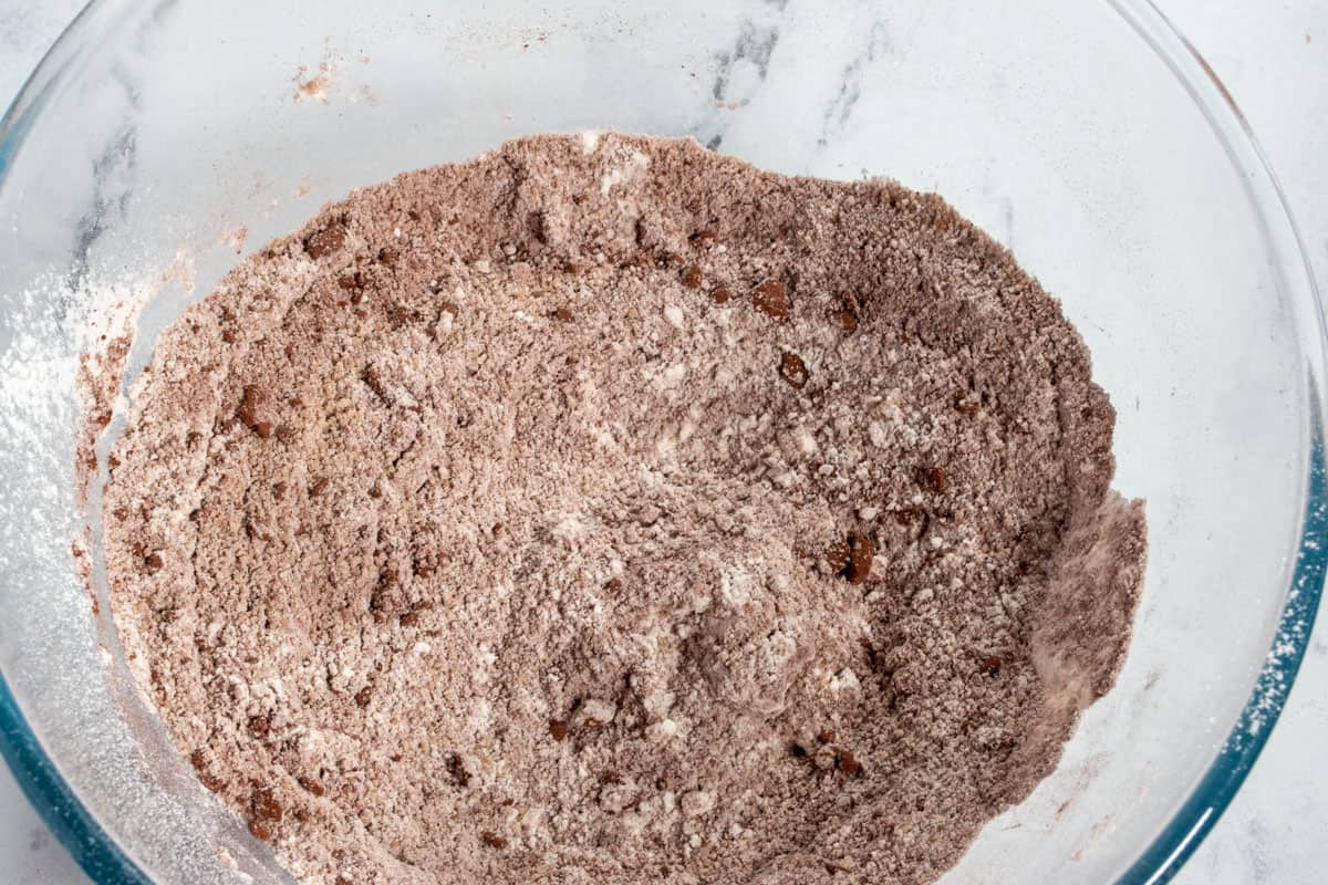 The dry ingredients for the chocolate cake combined inside a large bowl.