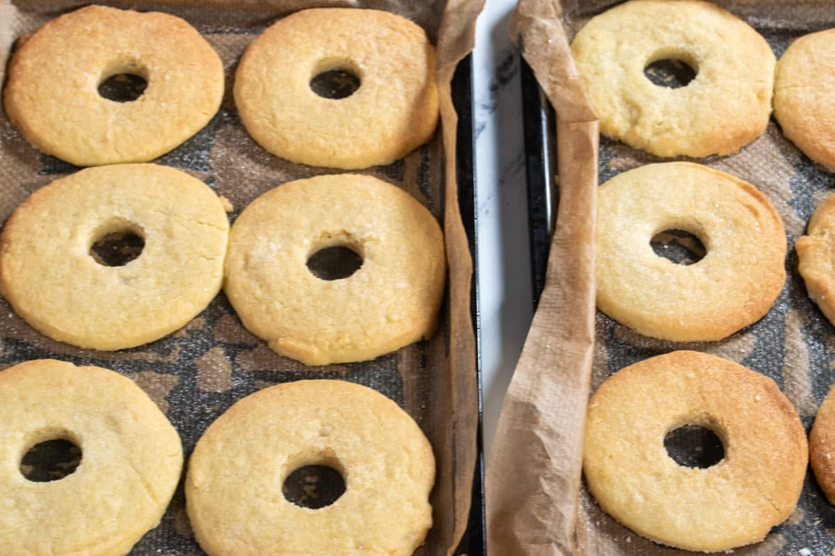 The shortbread has been baked and the holes have been cut out from the centers.