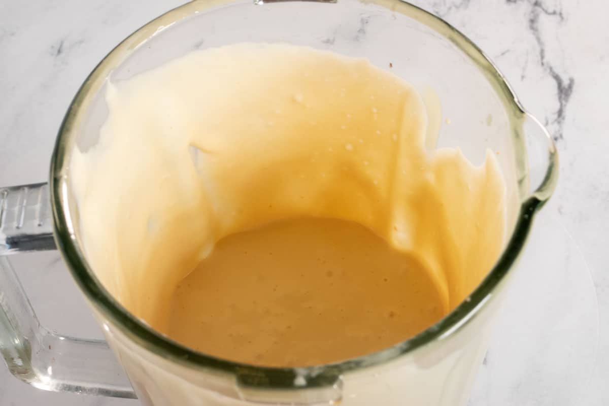 The main ingredients for the peanut butter filling combined inside the blender.