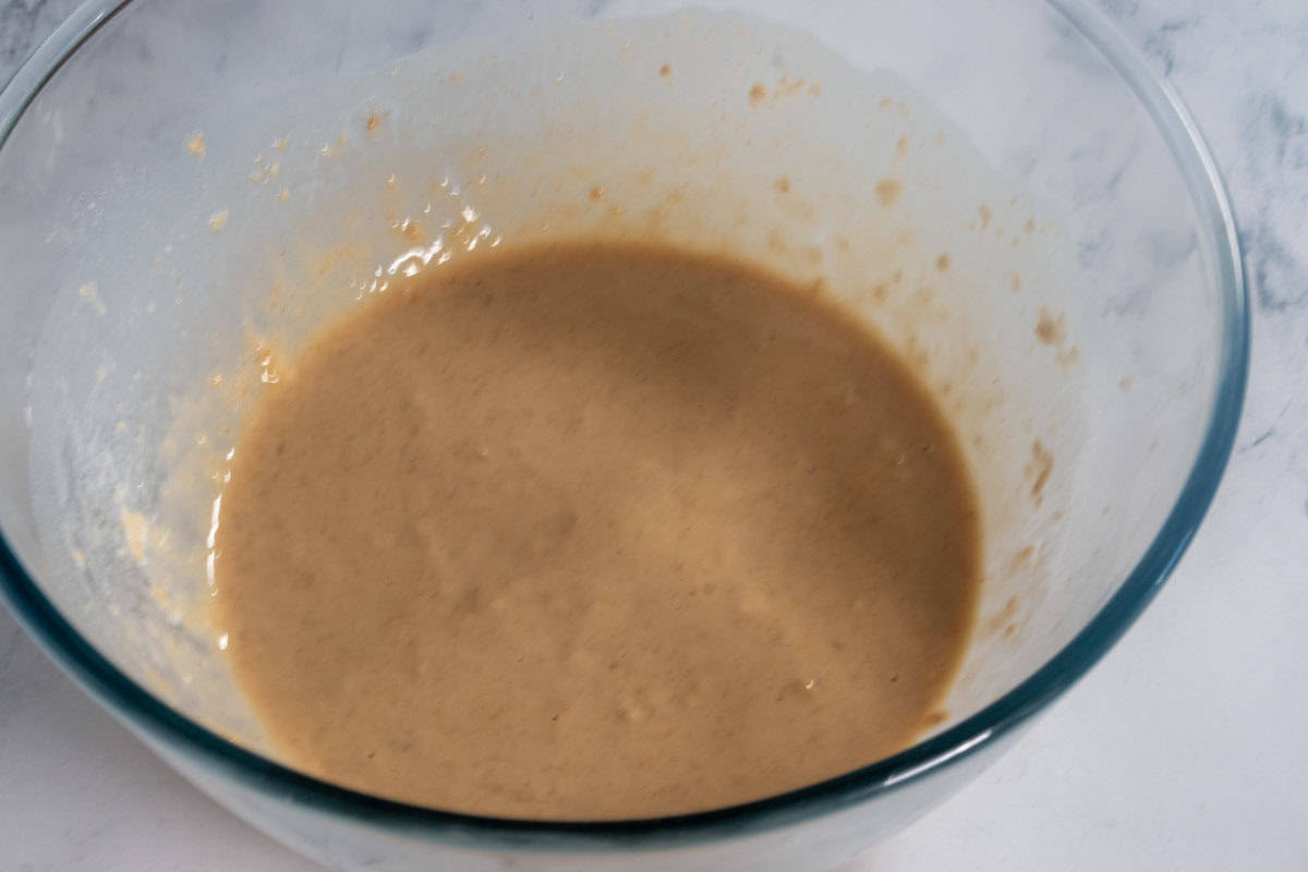 The soy milk has now been mixed in, forming a smooth vegan protein pancake batter. 